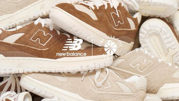 Pile of brown and cream New Balance sneakers stacked together.
